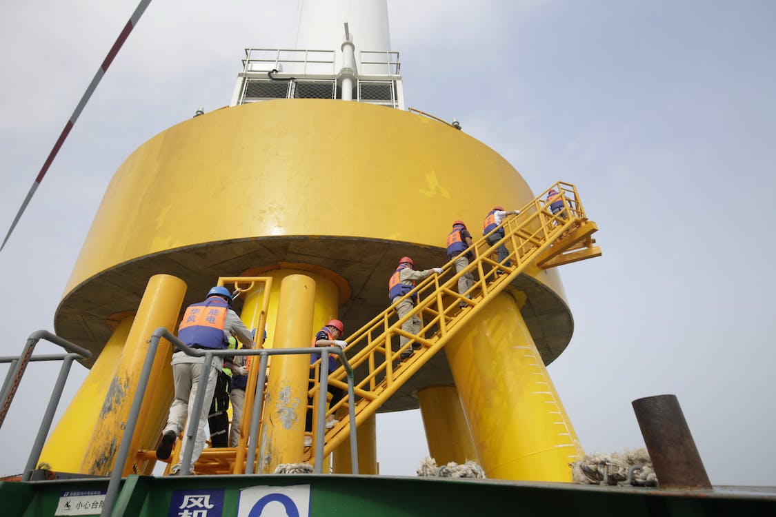 Workers walking upstairs on gas installation